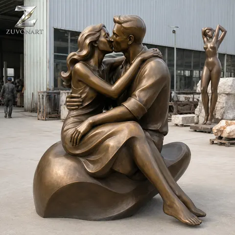 A seated couple is composed around a heart-shaped sculptural gesture.