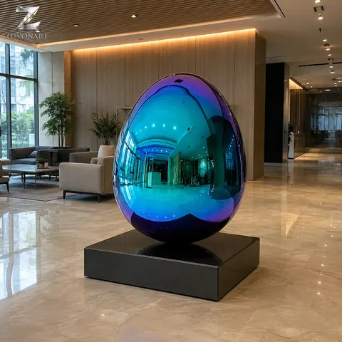 A smooth egg-like volume reflects a blue and violet color direction above a low plinth.