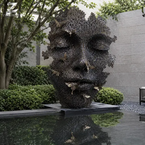 A large face-like relief is broken by irregular openwork apertures.