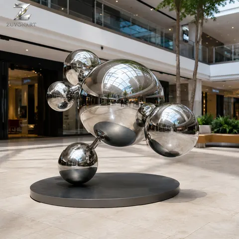 Reflective spheres appear stacked in a vertically offset balancing composition.