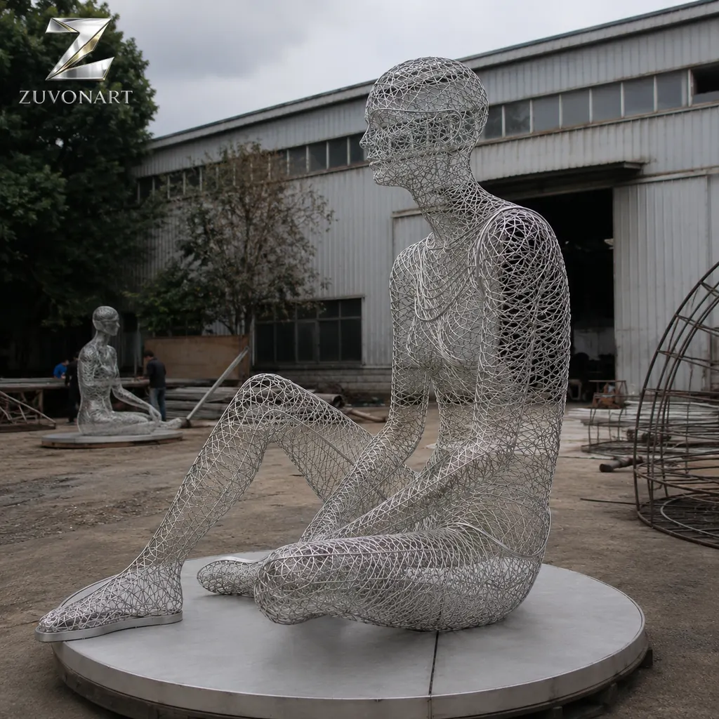 A seated meditative figure is suggested through a translucent wire-mesh surface.